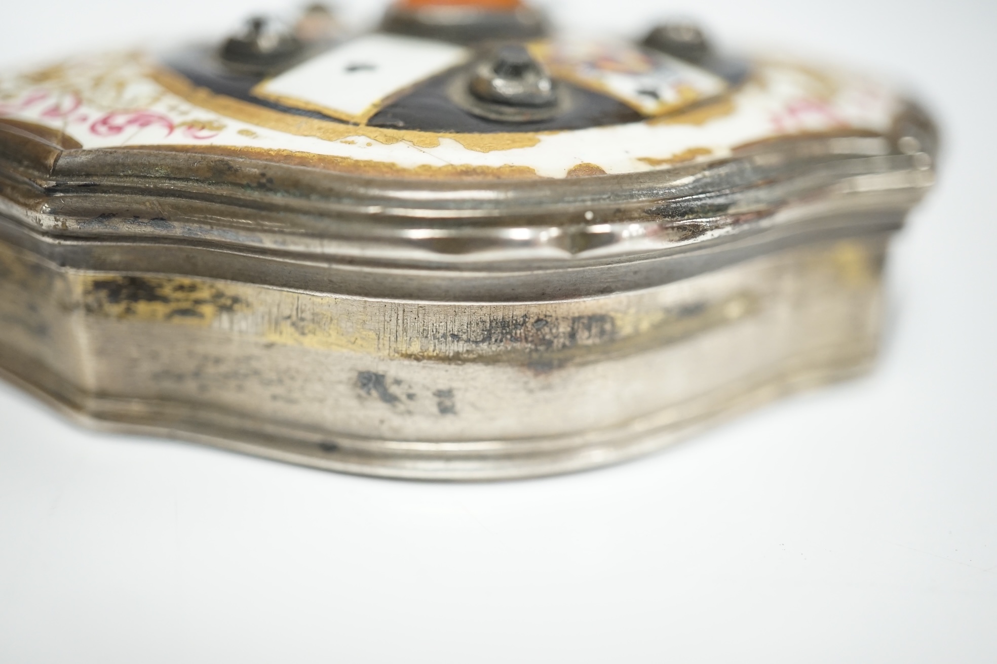 A continental white metal, enamel and two colour paste? set shaped oval snuff box, decorated with playing cards, unmarked, 67mm. Condition - poor